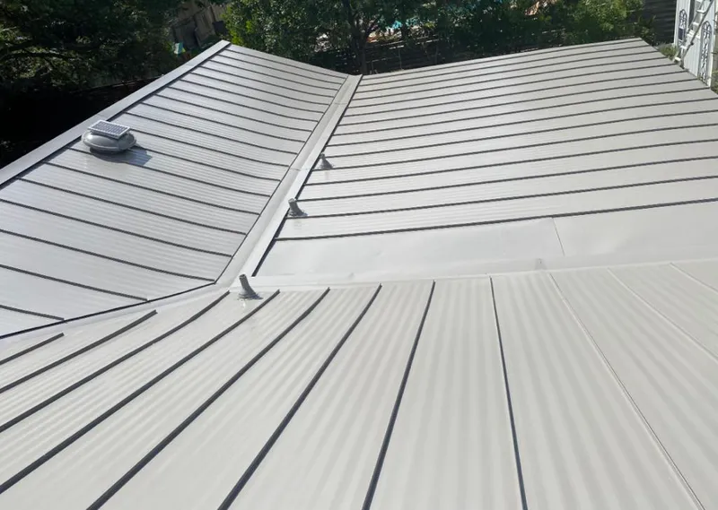 Solar attic fan installed on a metal roof for Roof Ventilation in Glasgow